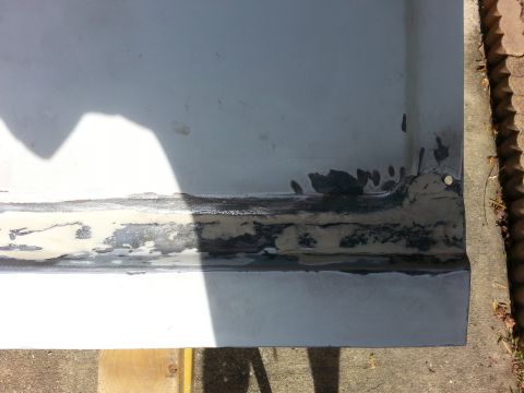 1992 Ford Bronco - This photo shows a section of a vehicle's body panel with evidence of rust and repair work.