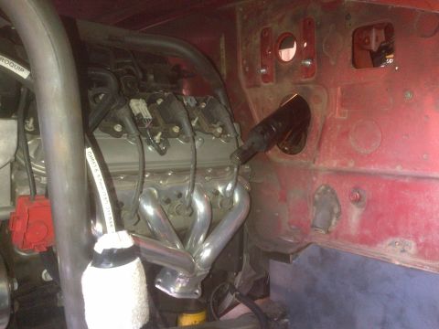 1985 Jeep CJ7 - Close-up of an engine bay, focusing on the exhaust manifold and associated wiring.