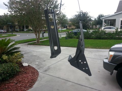 1994 Ford Bronco - Two car parts are being painted and hung to dry in front of a residential house.