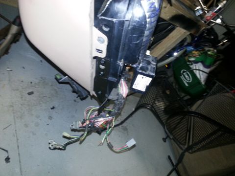 1994 Ford Bronco - A complex wiring harness with multiple colored wires is visible, attached to a vehicle's internal structure.