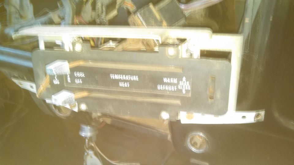 Climate control panel with text labels for temperature and fan speed, showing wires and internal components