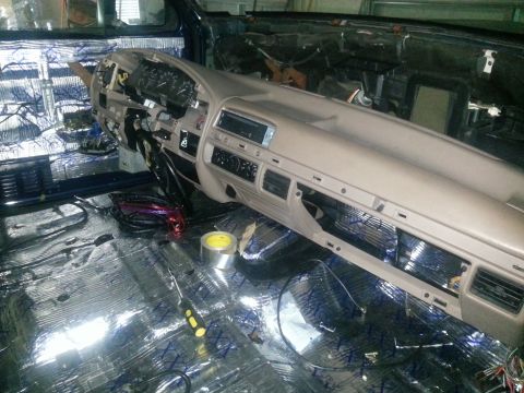 1994 Ford Bronco - Photograph of a truck cab with dash partially out and foil sound-deadening on the floor, not a technical document.