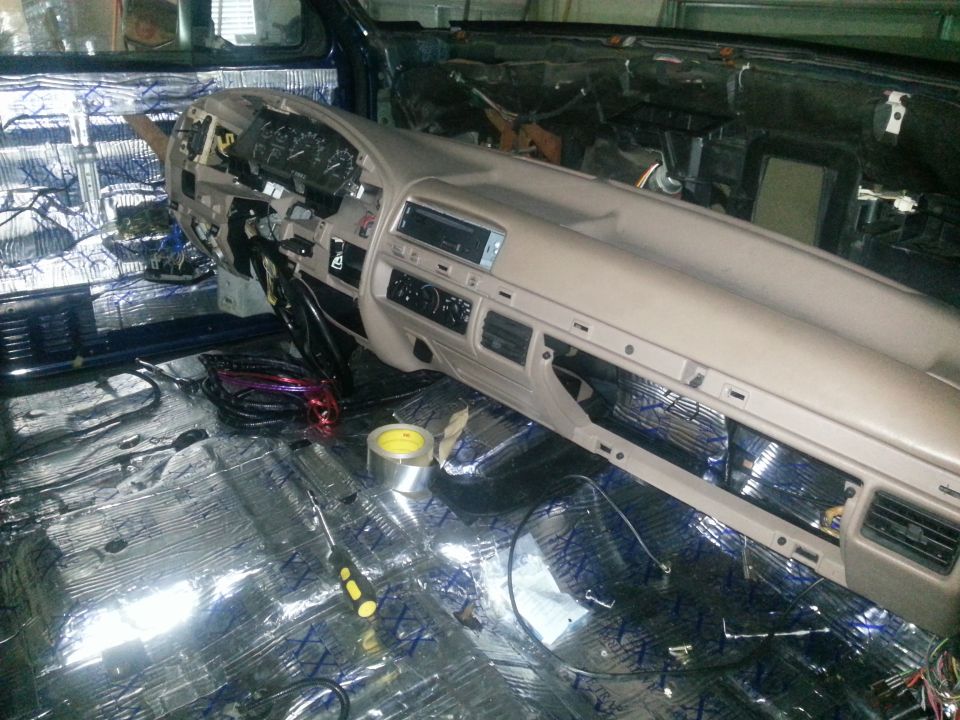 Photo of truck dashboard removed with engine bay and sound-deadened floor