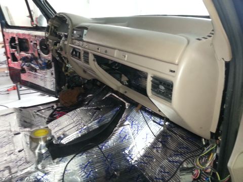 1994 Ford Bronco - Photograph of a truck cab dash and foil-covered floor during install, not a technical document.