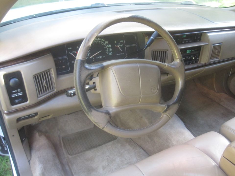 Interior of a 1995 Buick Roadmaster, showing dashboard, steering wheel, and center console.