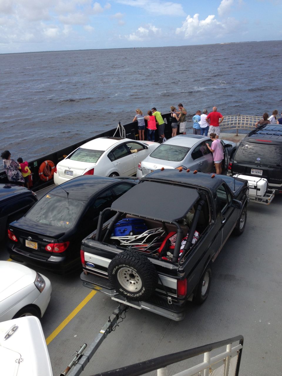 1993 Ford Bronco on a ferry, top removed, luggage in the bed.