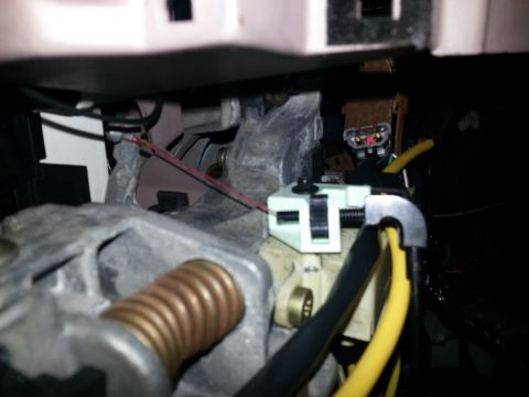 1994 Ford Bronco - Photograph of steering column hardware and connectors under the dash, not a technical document.