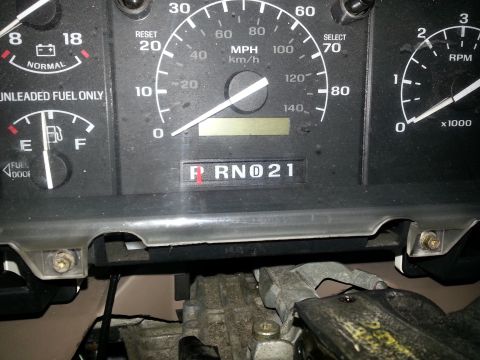 1994 Ford Bronco - Photograph of a vehicle instrument cluster with speedometer, fuel, and tachometer gauges, not a technical document.
