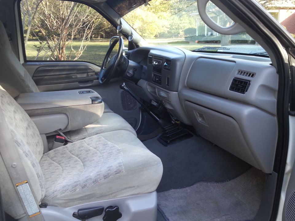Interior of a pickup truck showing dashboard, center console, and patterned fabric seats.