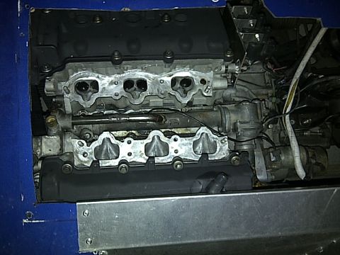 1995 Ford Probe - A close-up view of an engine's intake manifold and cylinder head assembly, with various hoses and wiring visible below.