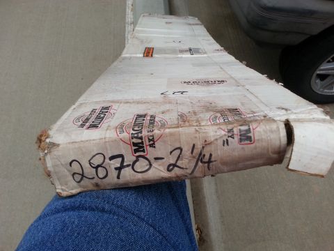 1965 Ford Mustang - A damaged cardboard box with the text "2870 - 2 1/4" written on it in marker, and "MAGNUM AXLE COMPANY" logos visible. The box is resting o…