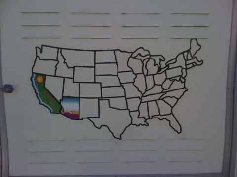 1997 Dodge 3500 - A map of the United States is displayed on a light-colored wall with horizontal lines. California and Arizona are depicted with colorful il…
