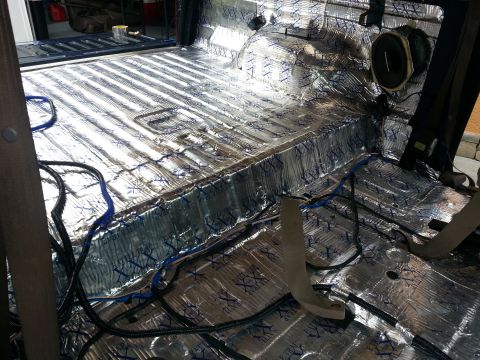 1994 Ford Bronco - Photograph of a truck cargo area lined with foil sound-deadening and audio wiring, not a technical document.
