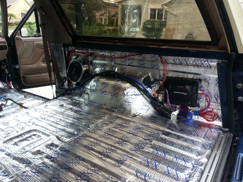 1994 Ford Bronco - Interior of a vehicle undergoing sound system installation, showing insulation and wiring.