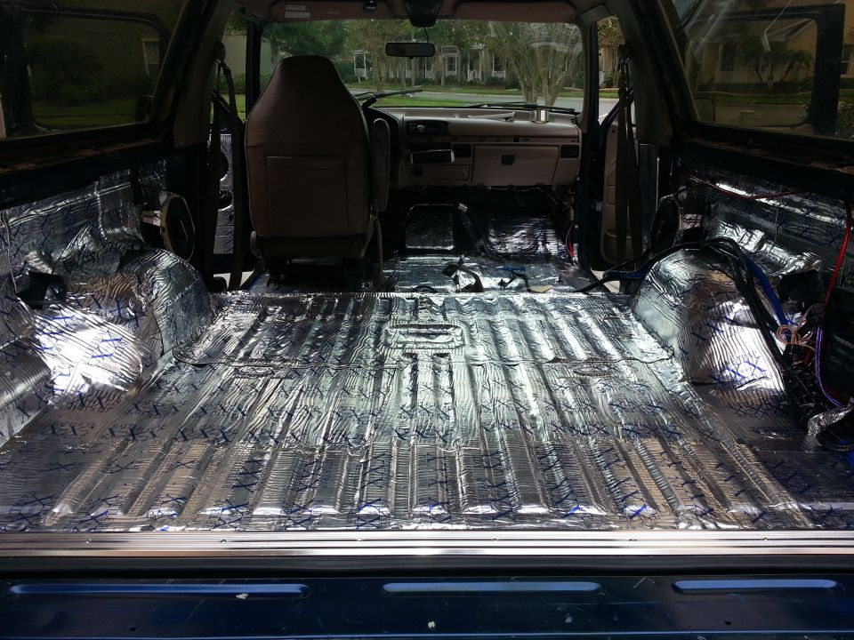 Interior of vehicle with sound deadening material applied to floor and rear cargo area