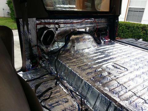 1994 Ford Bronco - Sound deadening insulation being installed in the interior of a vehicle.