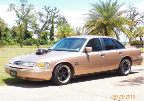 1993 Ford Crown Victoria - This modified 1993 Ford Crown Victoria features a prominent hood scoop and aftermarket wheels.