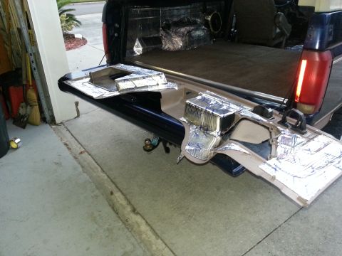 1994 Ford Bronco - Photograph of a pickup truck tailgate and bed lined with foil heat/sound-deadening material in a garage.