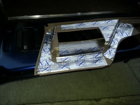 1994 Ford Bronco - Photograph of a vehicle interior panel laid out and covered with foil sound-deadening insulation.