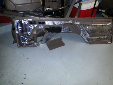 1994 Ford Bronco - Photograph of a removed vehicle interior side panel covered with foil sound-deadening material.