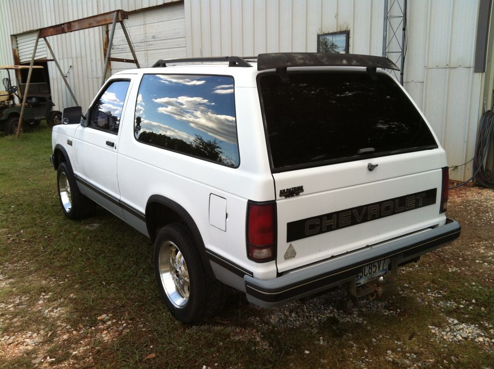 White 1988 Chevrolet Blazer, rear driver's side quarter view, with tinted windows and chrome wheels.