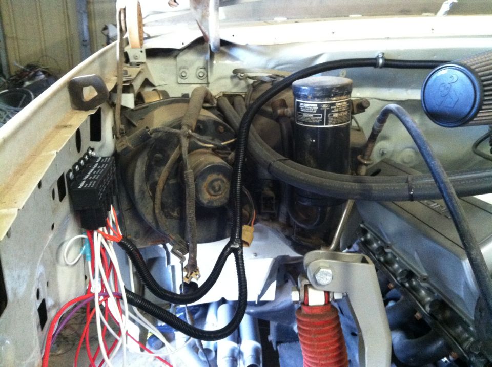 1991 Ford Bronco engine bay with fuse box, oil filter, and hoses