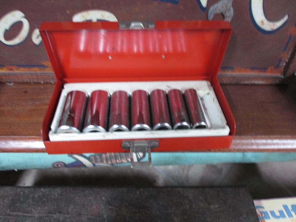 red metal toolbox with a set of chrome sockets inside