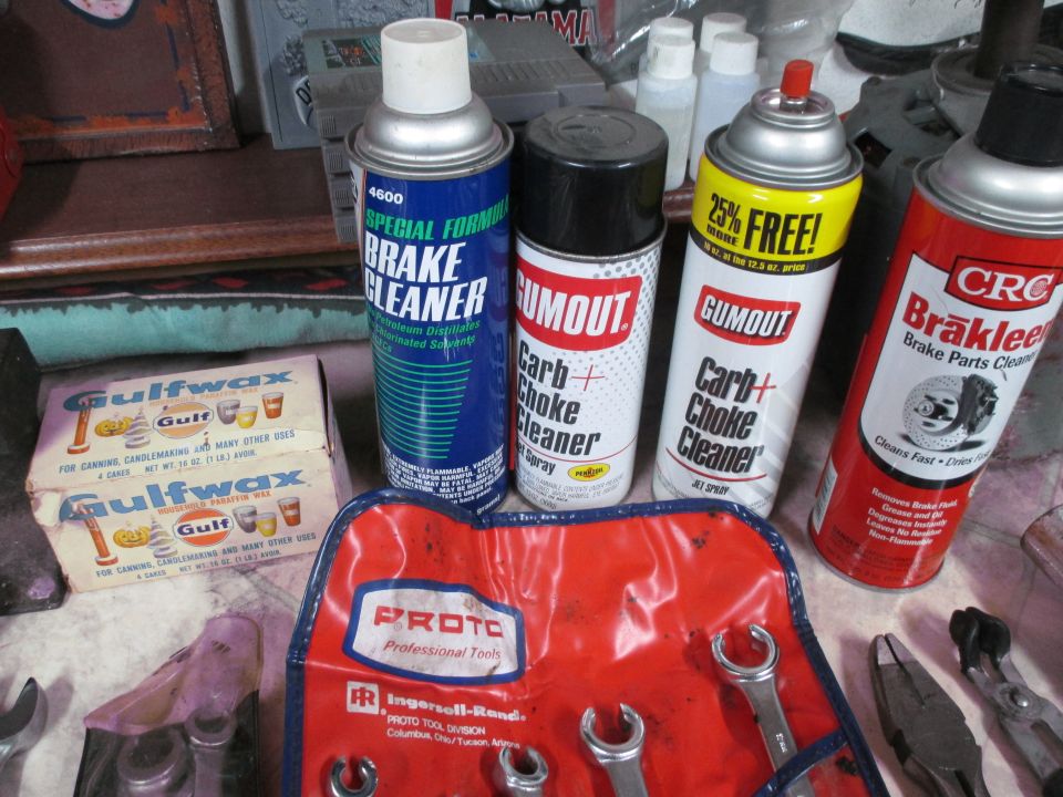 Automotive cleaning supplies including brake cleaner and carb cleaner, with a Proto tool roll