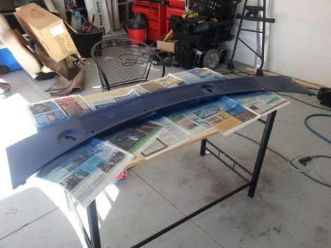 1994 Ford Bronco - A car's windshield cowl panel is drying on a table covered with newspapers.