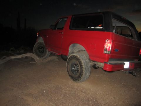 1996 Ford Bronco - This 1996 Ford Bronco is parked off-road at night with a log in front of it.