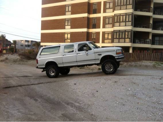 White 1995 Ford Bronco extended cab pickup truck side view