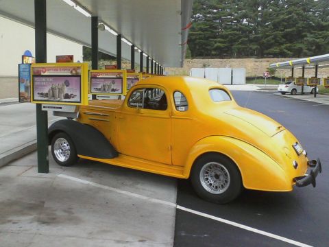 1935 Chevrolet New - 1935 Chevrolet coupe hot rod at a drive-in restaurant, with a second vehicle in the background.