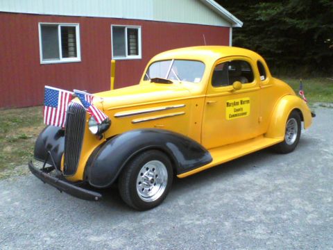 1935 Chevrolet New - This 1935 Chevrolet Coupe is decorated with American flags and a sign identifying a county commissioner.