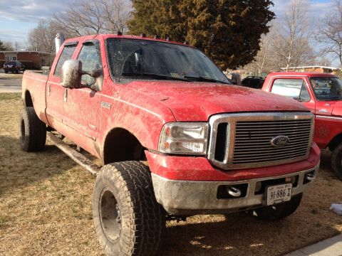 2007 Ford F-350 - This lifted 2007 Ford F-350 pickup truck is shown in a 3/4 front view, large tires and a prominent chrome grille.