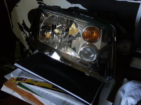 2002 Volkswagen Jetta - A single headlight assembly, likely for a Volkswagen Jetta, is shown with its clear lens and amber turn signal illuminated.