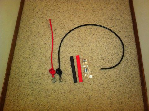 1982 Ford Bronco - Battery terminal cables, heat shrink tubing, and connectors laid out on a textured surface.