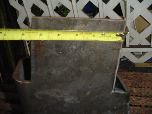 metal bracket being measured with a yellow tape measure