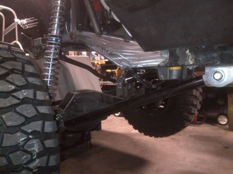 1985 Jeep CJ7 - Close-up view of the suspension and drivetrain of a modified off-road vehicle.