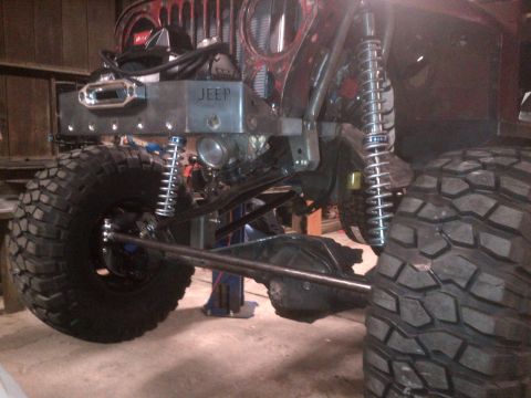 1985 Jeep CJ7 - Custom front suspension and axle assembly on a Jeep, large off-road tires and a winch.