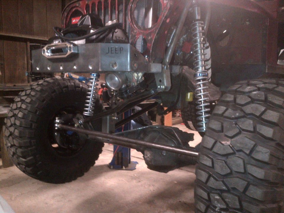 Jeep front end with large tires, winch, and custom bumper with 'JEEP' stamped on it