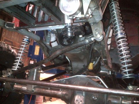 1985 Jeep CJ7 - Close-up view of a custom suspension and drivetrain, a skull motif on the differential cover.