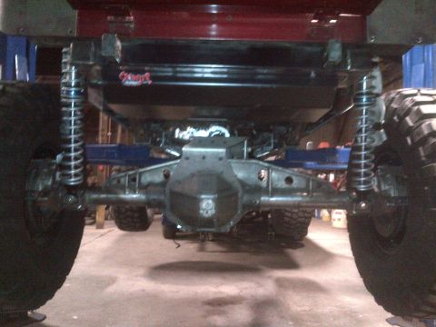 1985 Jeep CJ7 - Underside view of a heavily modified vehicle's rear axle and suspension system.