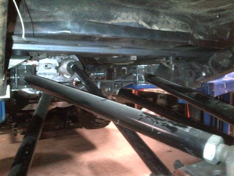1985 Jeep CJ7 - The undercarriage of a vehicle is shown, with various mechanical parts visible.