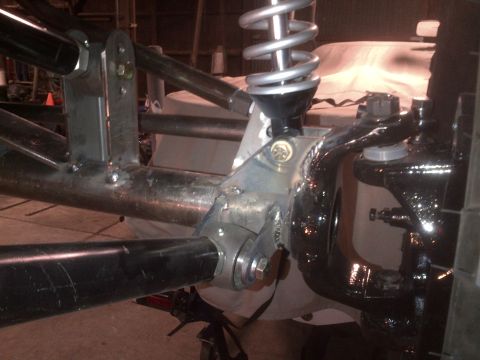 1985 Jeep CJ7 - Close-up of a custom suspension part, likely for off-road use, showing fabrication details.