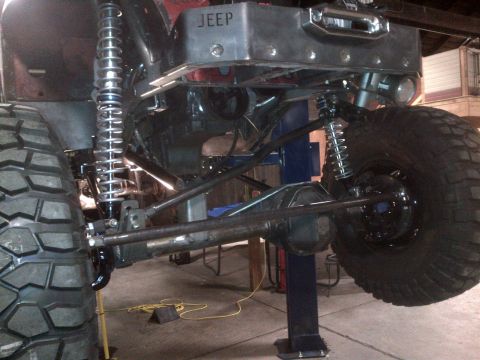 1985 Jeep CJ7 - Customized Jeep rear suspension and drivetrain components are visible, including a winch mounted above the axle.