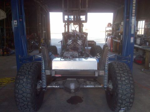 1985 Jeep CJ7 - This 1985 Jeep CJ7 is on a lift with its engine and fuel tank exposed.