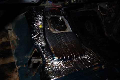 1995 Ford Bronco - The transmission tunnel interior is covered in black sound deadening material, obscuring the original vehicle details.