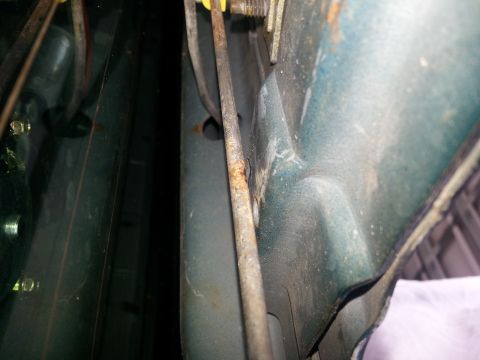 1994 Ford Bronco - Interior view of a car's door latch mechanism, showing wear and rust on metal components.