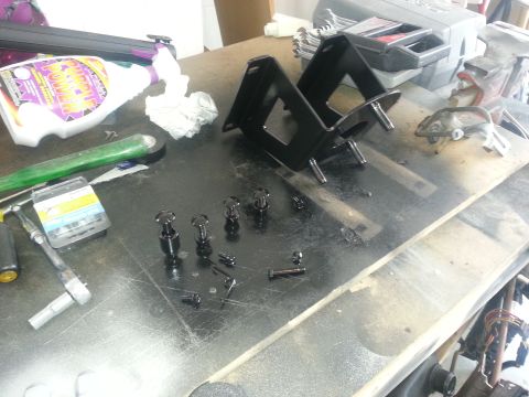 1994 Ford Bronco - Various vehicle parts and tools are organized on a workbench, ready for assembly or maintenance.
