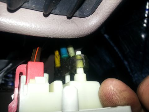1994 Ford Bronco - A close-up view of a vehicle's interior wiring harness, showing various colored wires connected to electrical components.